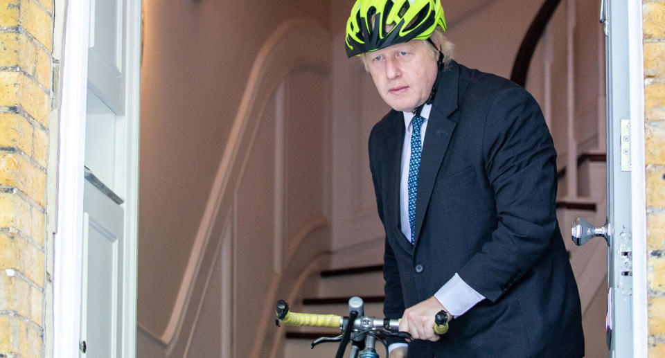 Former Mayor of London Boris Johnson is seen leaving his London home with a bicycle. He could replace British Prime Minister Theresa May after she resigned on Friday.