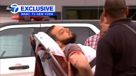 A still image captured from a video from WABC television shows a conscious man believed to be New York bombing suspect Ahmad Khan Rahami being loaded into an ambulance after a shoot-out with police in Linden, New Jersey, U.S., September 19, 2016. Courtesy WABC-TV via REUTERS