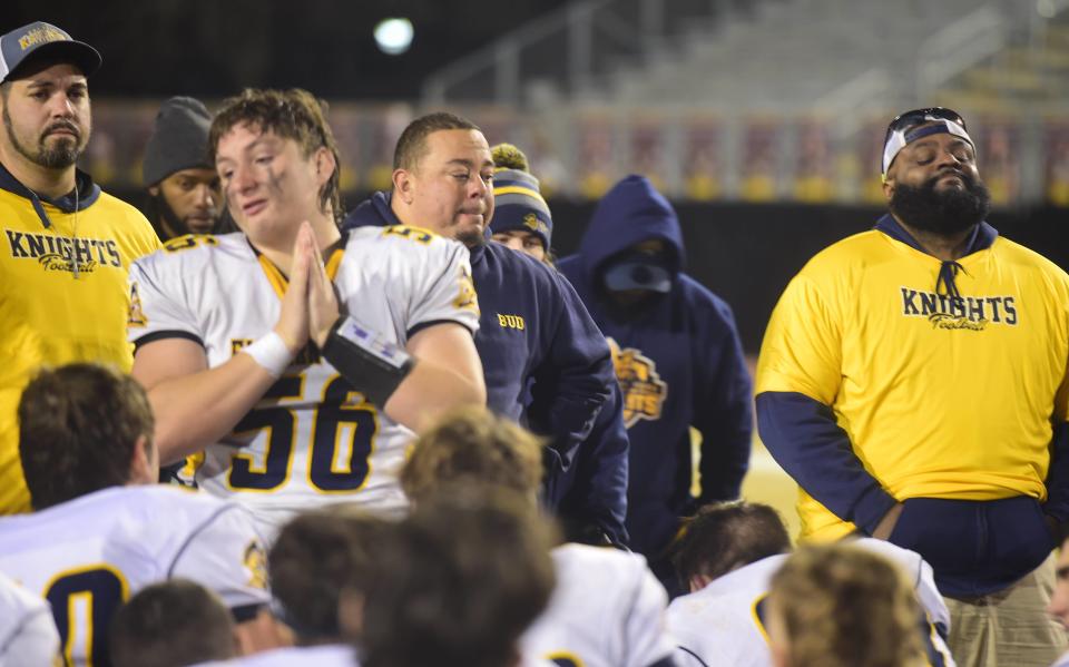 Eastern York senior lineman Emery McCombs addresses his teammates while coaches including head coach Bud Kyle (middle right) look on following a road playoff game against Milton Hershey Friday, Nov. 3, 2023. Eastern York lost, 29-23, to finish 7-4.