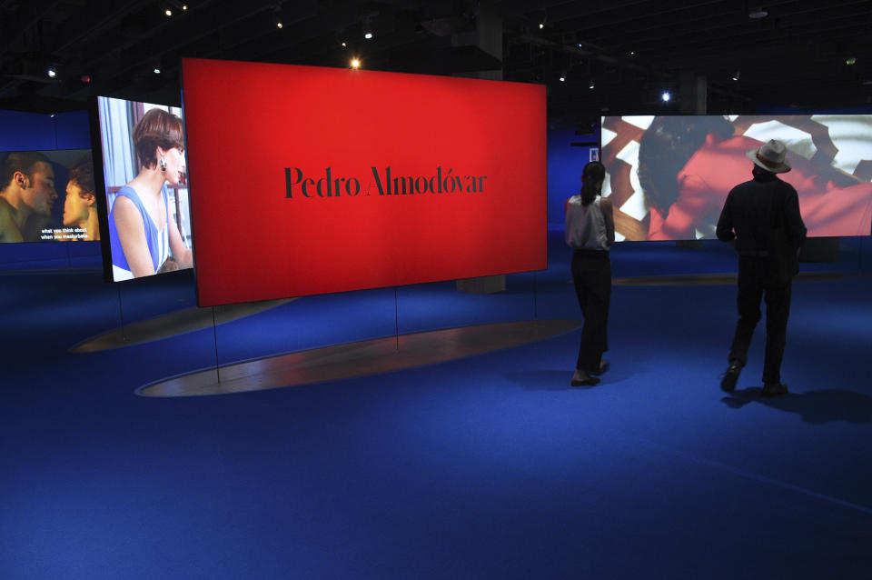 FILE - People view the Pedro Almodóvar exhibit at the Academy Museum on Tuesday, Sept. 21, 2021, in Los Angeles. The Academy Museum of Motion Pictures opens in Los Angeles Thursday. (Photo by Richard Shotwell/Invision/AP)