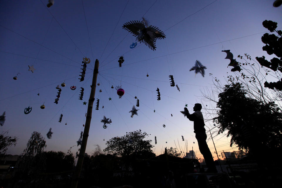 A man hangs Christmas decorations in Islamabad, Pakistan