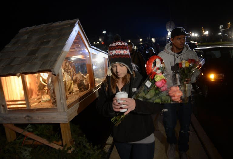 People gather for a prayer vigil at St Rose of Lima Church in Newtown, Connecticut, December 14, 2012. The residents of the idyllic Connecticut town were reeling in horror Saturday from the massacre of 20 small children and six adults at a school, in one of the worst mass shootings in US history