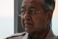 Malaysia's interim leader Mahathir Mohamad leaves after delivering a speech at the committee on the exercise of the inalienable rights of the Palestinian people, in Kuala Lumpur, Malaysia, Friday, Feb. 28, 2020. The speaker of Malaysia's House rejected Mahathir Mohamad's call for a vote next week to chose a new premier, deepening the country's political turmoil after the ruling alliance collapsed this week. (AP Photo/Vincent Thian)