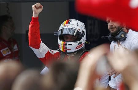 Formula One - F1 - Malaysian Grand Prix 2015 - Sepang International Circuit, Kuala Lumpur, Malaysia - 29/3/15 Ferrari's Sebastian Vettel celebrates winning the Malaysian Grand Prix Reuters / Olivia Harris Livepic