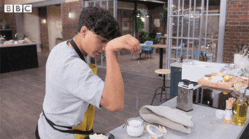 Sprinkling salt on a dish in the style of Salt Bae