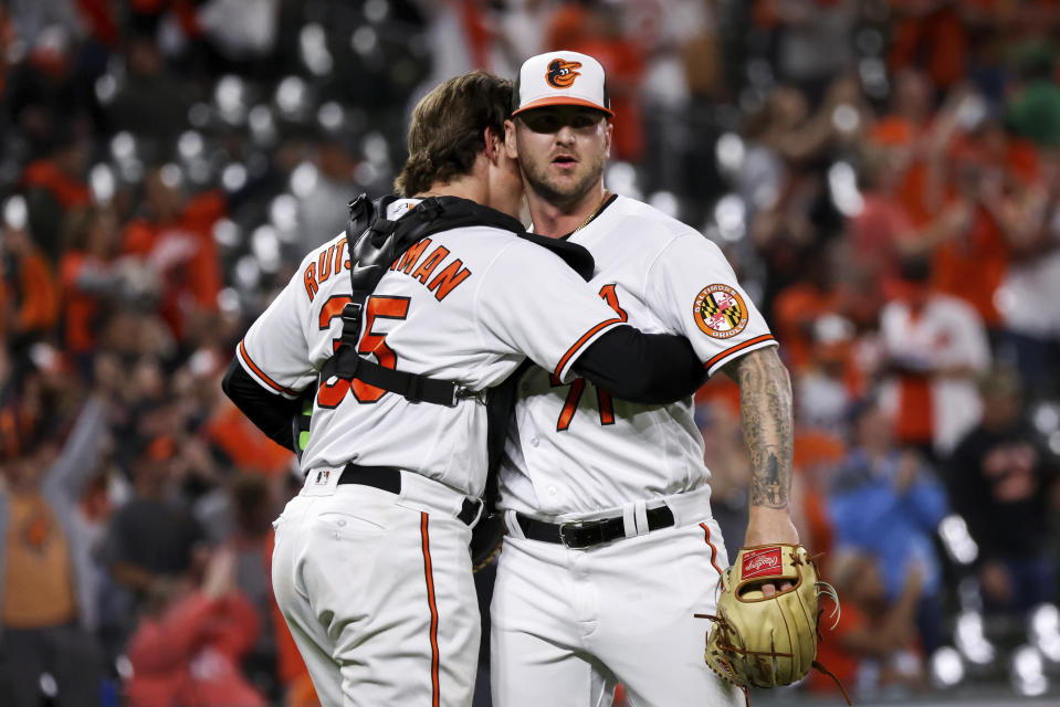 Baltimore Orioles relief pitcher Logan Gillaspie (71) and catcher Adley Rutschman (35) hug after defeating the Oakland Athletics in a baseball game, Tuesday, April 11, 2023, in Baltimore. The Orioles won 12-8. (AP Photo/Julia Nikhinson)