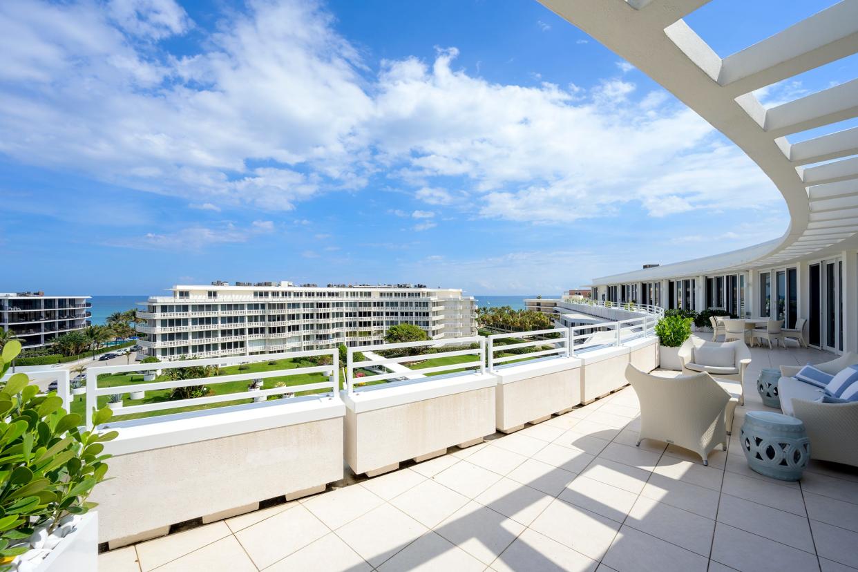 The broad, curved balcony of penthouse No. 5 at the Sun & Surf offers ocean views and plenty of room for lounging, dining and entertaining.