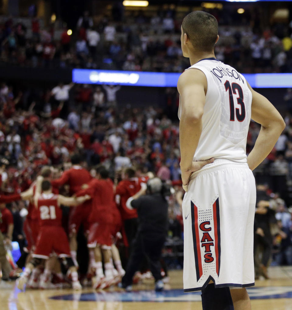 Arizona's Nick Johnson watches as Wisconsin celebrates after overtime in a regional final NCAA college basketball tournament game, Saturday, March 29, 2014, in Anaheim, Calif. Wisconsin won 64-63 in overtime. (AP Photo/Jae C. Hong)