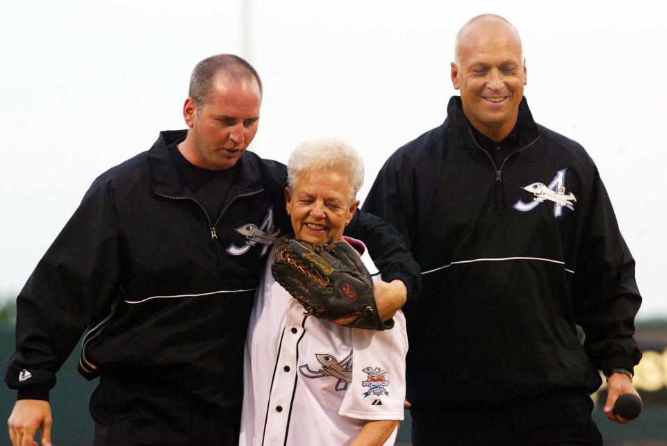 FILE - In this June 18, 2002, file photo, Cal Ripken Jr., right, owner of the Aberdeen IronBirds, and his brother, Bill, walk off the field with their mother, Vi, after she threw out the ceremonial first pitch prior to the team's season-opening debut at the new Ripken Stadium in Aberdeen, Md. Vi, matriarch of the famed Orioles family that includes Hall of Fame son Cal Jr. and once the victim of a bizarre kidnapping, has died. She was 82. Family spokesman John Maroon said she died Friday, Feb. 26, 2021, a day before her birthday. (AP Photo/Roberto Borea, File)