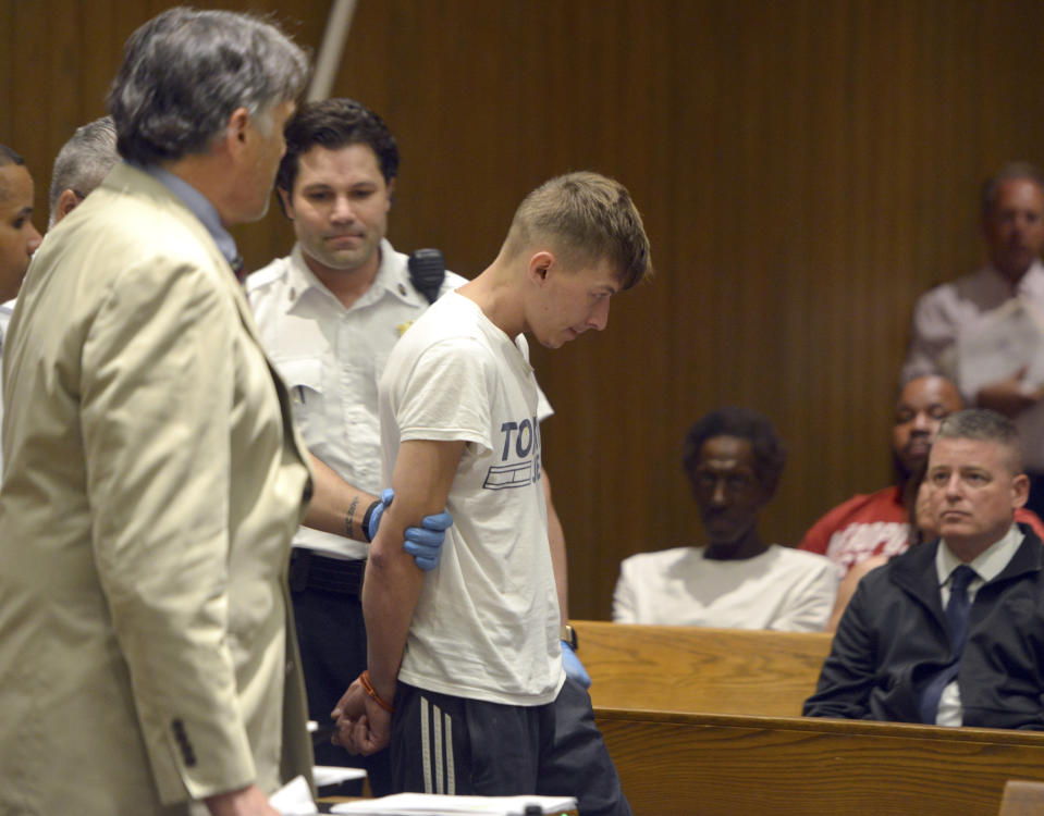 CORRECTS TO SPRINGFIELD NOT HAMPTON DISTRICT COURT - Volodymyr Zhukovskyy, 23, of West Springfield, is escorted into the courtroom for his arraignment in Springfield District Court, Monday, June 24, 2019, in Springfield, Mass. Zhukovskyy, the driver of a truck in a fiery collision on a rural New Hampshire highway that killed seven motorcyclists, was charged Monday with seven counts of negligent homicide. (Don Treeger/The Republican via AP, Pool)