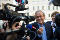 The former president of the the European Football Association (Uefa), Michel Platini, center, surrounded by media representatives, speaks to the press in front of the Swiss Federal Criminal Court in Bellinzona, Switzerland, at the last day of the trail, after the verdict has been announced, Friday, July 8, 2022. The trial ended with an acquittal. Former Fifa President Joseph Blatter and Platini, stood trial before the Federal Criminal Court over a suspicious two-million payment. The Federal Prosecutor's Office accused them of fraud. The defense spoke of a conspiracy. (Ti-Press/Alessandro Crinari/Keystone via AP)