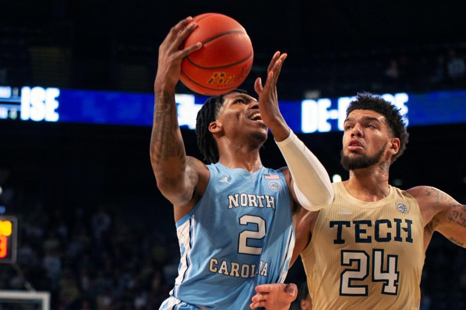 North Carolina guard Caleb Love, left, goes up for a driving shot against Georgia Tech center Rodney Howard during the ACC opener for both teams Sunday at McCamish Pavilion.