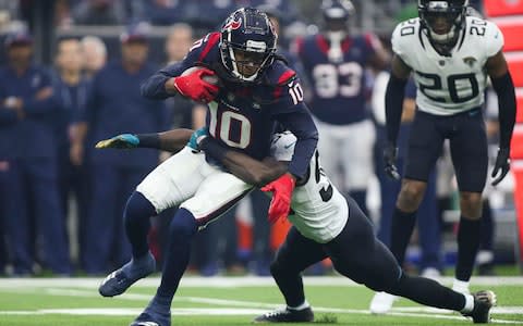 Houston Texans wide receiver DeAndre Hopkins (10) makes a reception as Jacksonville Jaguars outside linebacker Telvin Smith (50) attempts to make a tackle during the first quarter at NRG Stadium - Credit: USA TODAY