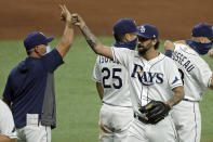 Tampa Bay Rays relief pitcher Chaz Roe, right, celebrates with manager Kevin Cash after closing out the New York Yankees during the ninth inning of a baseball game Friday, Aug. 7, 2020, in St. Petersburg, Fla. (AP Photo/Chris O'Meara)