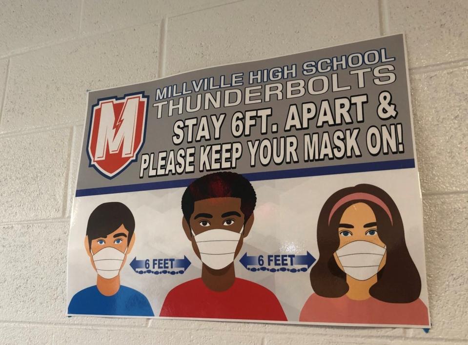 A sign at Millville High School reminds students to wear masks to fight the spread of COVID-19. Millville, as of Jan. 3, stuck to an in-person learning model. Other districts across South Jersey have varying plans.