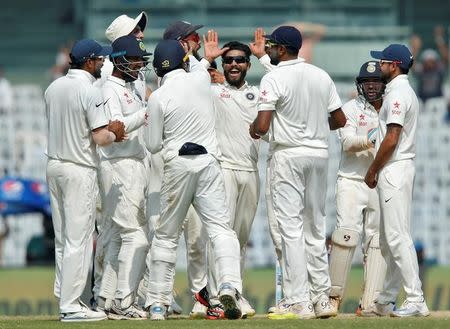 Cricket - India v England - Fifth Test cricket match - M A Chidambaram Stadium, Chennai, India - 20/12/16. Ravindra Jadeja (2nd R) celebrates with team mates the dismissal of England's Joe Root. REUTERS/Danish Siddiqui