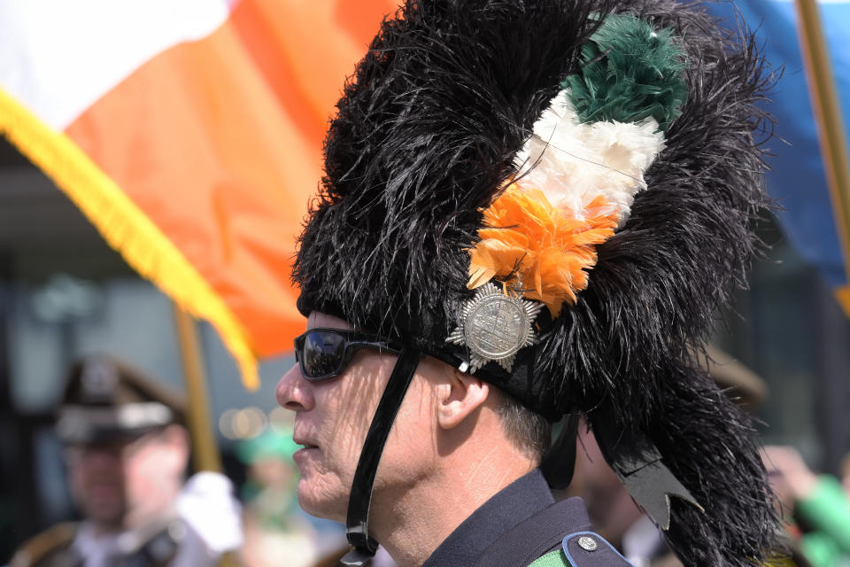 A member of the Boston Police Gaelic Column of Pipes and Drums wears a feather in his hat with colors from the Irish flag before the Patrick's Day parade, Sunday, March 17, 2024, in Boston's South Boston neighborhood. (AP Photo/Steven Senne)