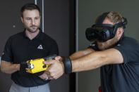 VR equipment and a version of the TASER 7 that utilizes VR technology for training, is demonstrated, Thursday, May 12, 2022, in Washington. (AP Photo/Jacquelyn Martin)