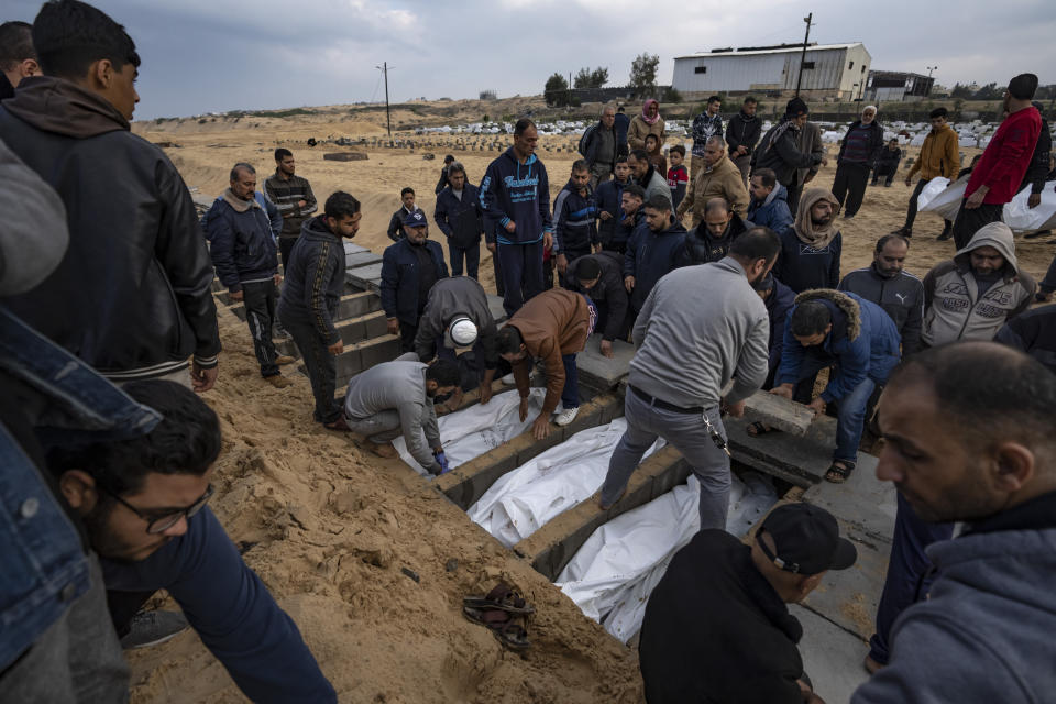Palestinians bury their relatives killed in the Israeli bombardment of the Gaza Strip, at a cemetery in Rafah, southern Gaza, Thursday, Dec. 14, 2023. (AP Photo/Fatima Shbair)