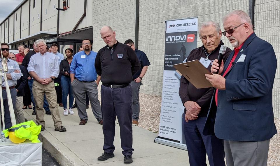 Jeff Cline, president of the Washington County commissioners, reads a proclamation as Henry Koschitzky and others look on during Thursday's grand-opening celebration for the IKO manufacturing facility just outside Hagerstown off Western Maryland Parkway. The Koschitzky family owns the company, which is based in Canada and makes roofing, waterproofing and insulation products.