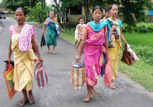 Bodo tribal people flee their homes in Kokrajhar district near Guwahati, in Assam state during violent clashes on July 23. New clashes took the death toll from ethnic violence in India's remote northeast to 22 on Tuesday despite an official curfew backed by shoot-on-sight orders, police said