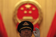 A Chinese military conductor gestures as he instructs his music band members during a rehearsal for the opening session of the China's National People's Congress at the Great Hall of the People in Beijing, Tuesday, March 5, 2019. (AP Photo/Andy Wong)