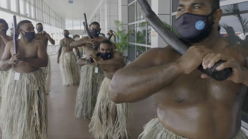 Performers greet travellers in the terminal upon arrival at Nadi Airport, Fiji in this still frame obtained from handout video dated December 1, 2021