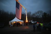 NEWTOWN, CT - DECEMBER 18: A flag hangs over a memorial for shooting victims on December 18, 2012 in Newtown, Connecticut. Funeral services were held in Newtown Tuesday for Jessica Rekos and James Mattioli, both age six, four days after 20 children and six adults were killed at Sandy Hook Elementary School. (Photo by John Moore/Getty Images)