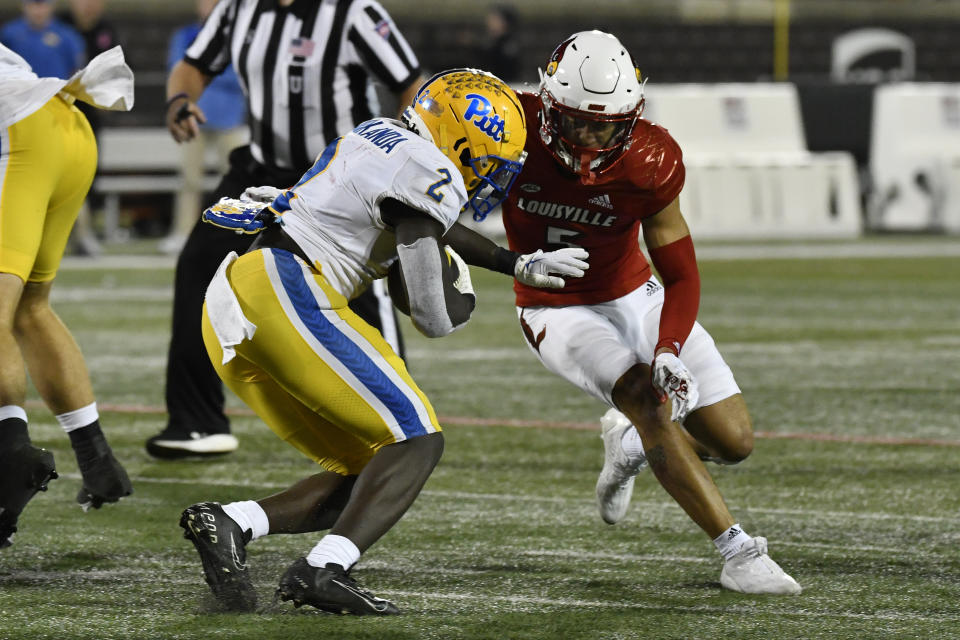 Louisville defensive back Josh Minkins (5) hits Pittsburgh running back Israel Abanikanda (2) during the second half of an NCAA college football game in Louisville, Ky., Saturday, Oct. 22, 2022. (AP Photo/Timothy D. Easley)