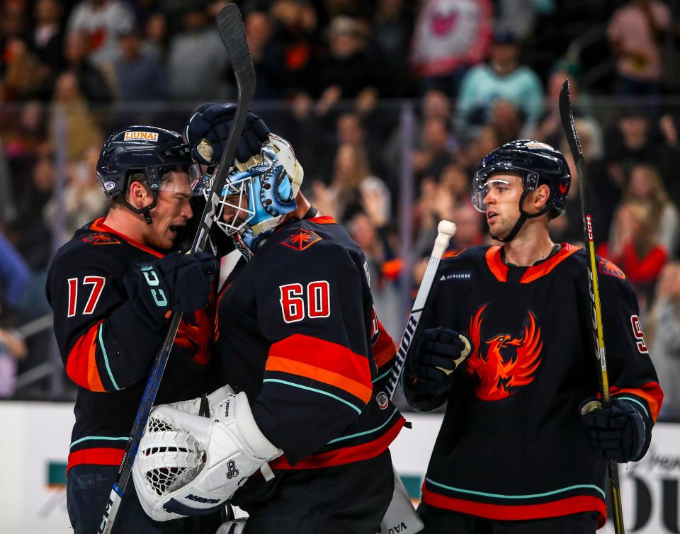 Coachella Valley forward Max McCormick (17) celebrates a win with goaltender Chris Driedger (60) after their game at Acrisure Arena in Palm Desert, Calif., Thursday, April 4, 2024.