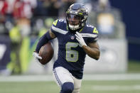 Seattle Seahawks free safety Quandre Diggs runs with the ball after he intercepted a pass against the San Francisco 49ers during the second half of an NFL football game, Sunday, Dec. 5, 2021, in Seattle. (AP Photo/Elaine Thompson)