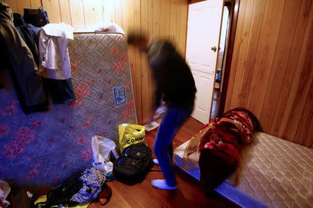 Ali Rasooli, a refugee from Afghanistan, packs a bag in a house he rents with other refugees, in the western Sydney suburb of Guildford, Australia, July 17, 2016. REUTERS/David Gray