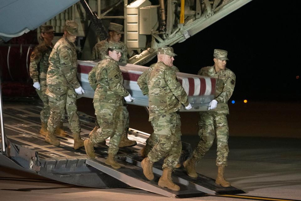 The remains of Ensign Joshua Kaleb Watson, fatally shot at the Naval Air Station Pensacola in Florida, are transferred at Dover Air Force Base in Delaware on Dec. 8, 2019.