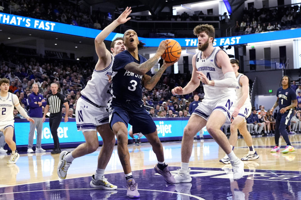 Penn State guard Nick Kern Jr. (3) drives to the basket past Northwestern guard Ryan Langborg, left, and center Matthew Nicholson, right, during the first half of an NCAA college basketball game in Evanston, Ill., Sunday, Feb. 11, 2024. (AP Photo/Nam Y. Huh)