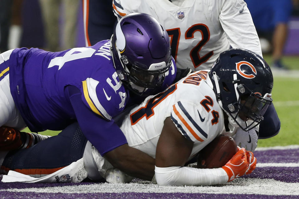 Chicago Bears running back Jordan Howard (24) scores on a 1-yard touchdown run ahead of Minnesota Vikings defensive tackle Jaleel Johnson (94) during the first half of an NFL football game, Sunday, Dec. 30, 2018, in Minneapolis. (AP Photo/Bruce Kluckhohn)