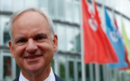 E.ON CEO Johannes Teyssen poses in front of the E.ON headquarters after a news conference in Essen