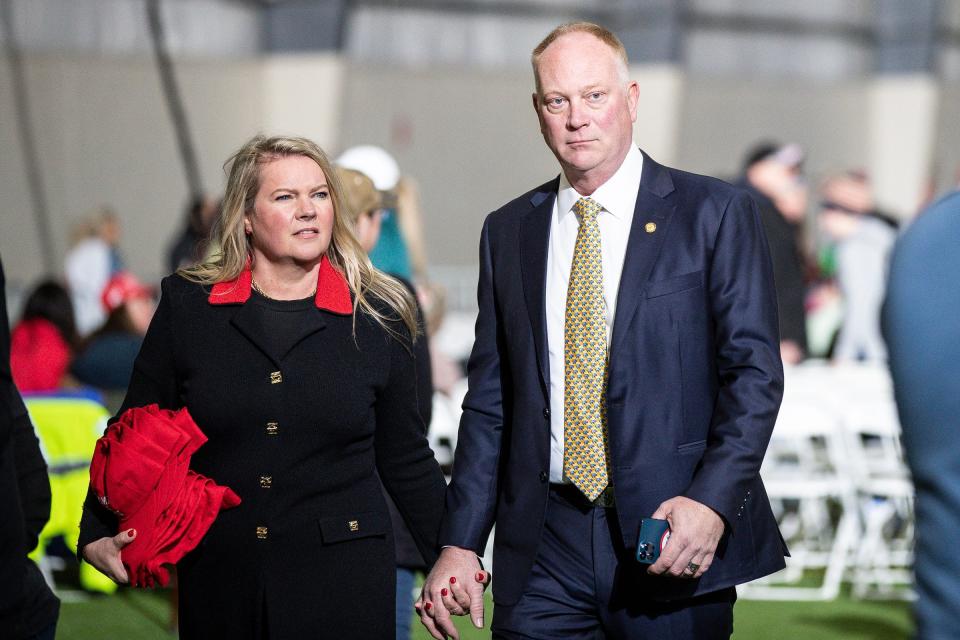 State Rep. Matt Maddock, right, walks around with his wife, Meshawn Maddock, before a Save America rally at the Michigan Stars Sports Center in Washington Township on April 2, 2022.