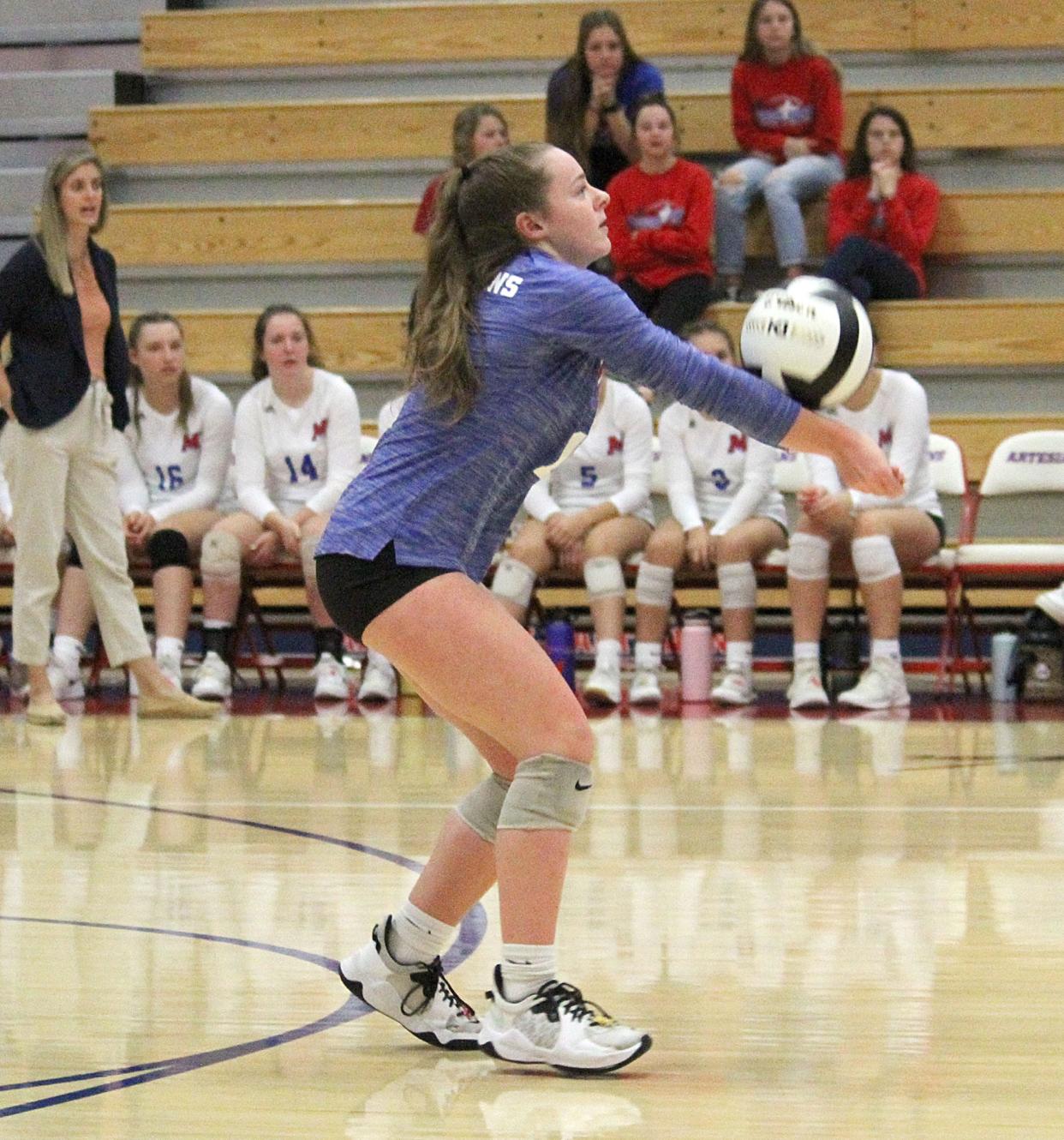 Martinsville junior Molly Urban gets a kill during Saturday's IHSAA Sectional semi-final game against Bedford North Lawrence at home.