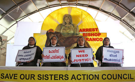 FILE PHOTO: Nuns hold placards during a protest demanding justice after an alleged sexual assault of a nun by a bishop in Kochi, in the southern state of Kerala, India, September 13, 2018. The placards read in Malayalam "Why is the government silent?', 'Police, do justice', and "Our lives are threatened'. REUTERS/Sivaram V/File Photo