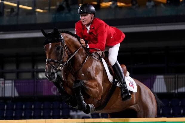 Canada's Mario Deslauriers, seen competing at the Tokyo Olympics, finished fifth at the CP International show jumping competition at Spruce Meadows in Calgary on Sunday.   (Carolyn Kaster/Associated Press  - image credit)