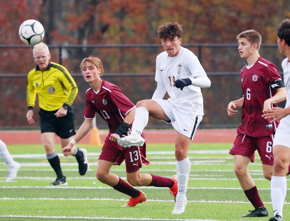Arlington's Dylan Manriquez (19) clears the ball away from Kingston defenders during the boys Class AAA soccer regional final at FDR - Hyde Park Nov. 4, 2023.