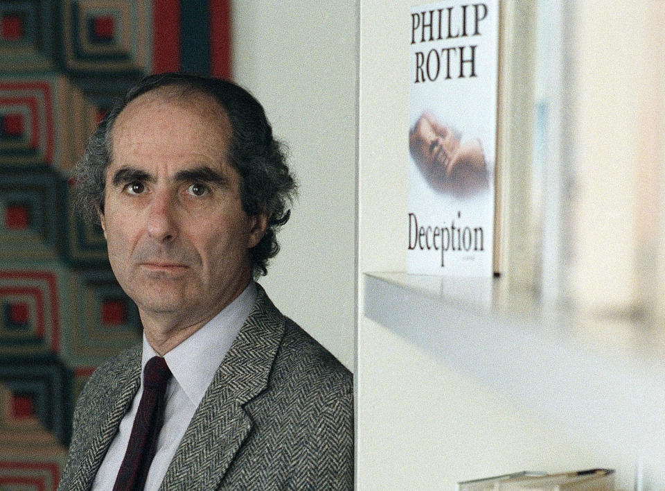 FILE - In this July 2, 1990 file photo, author Philip Roth poses in the offices of Simon and Schuster where promotion is underway for his latest novel, “Deception,” in New York. A documentary on Roth airing in March 2013, as the author turns 80, outlines his life and work, from his childhood in Newark, N.J., to such controversial novels as the ribald "Portnoy's Complaint" to his current status as literary eminence and perennial Nobel candidate. But the documentary "Philip Roth: Unmasked" leaves out Roth's news-making decision, which he revealed last fall, to stop writing novels. He is presented as an active writer, with shots of him at work in his Connecticut home. (AP Photo/Wyatt Counts, File)