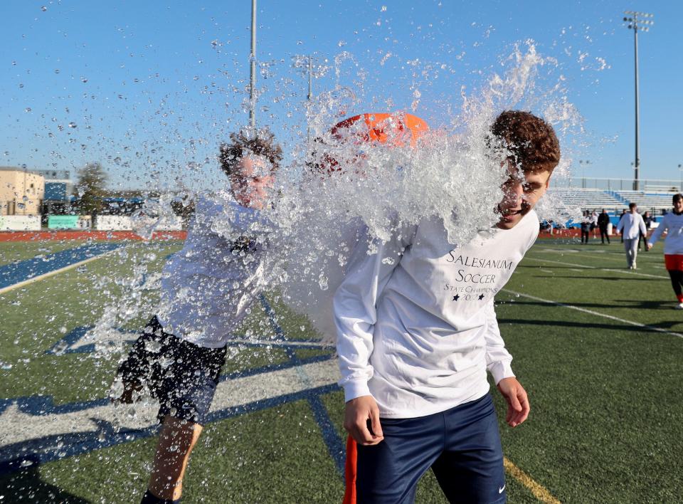 Salesianum teammates douse senior Jake Ross after winning the DIAA Division I Boys Soccer championship with a 4-1 victory over Charter of Wilmington on Saturday at Dover High.