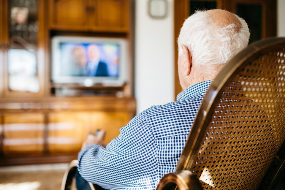 senior woman watching tv at home