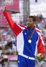 Javier Sotomayor of Cuba waves to crowd after receiving his gold medal in the high jump 30 July 1999 at the Pan American Games in Winnipeg, Canada. Sotomayor won with a jump of 2.30 meters. (ELECTRONIC IMAGE) AFP PHOTO/Jeff HAYNES