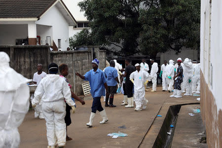 Health workers wait at the entrance of the mortuary at the Connaught Hospital in Freetown, Sierra Leone August 16, 2017. REUTERS/Afolabi Sotunde