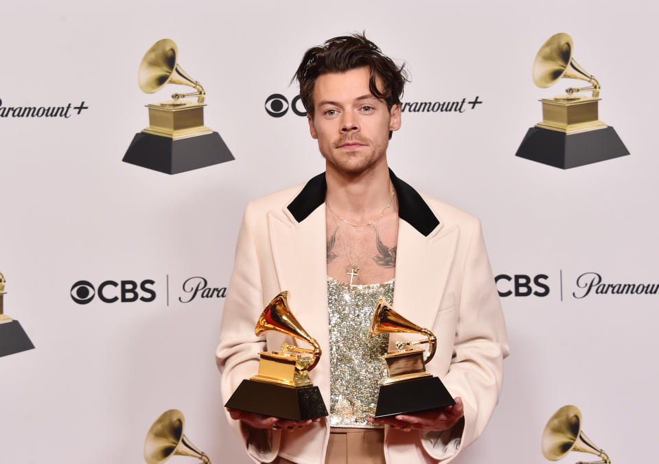 Harry Styles poses with two trophies at the 2023 Grammy Awards