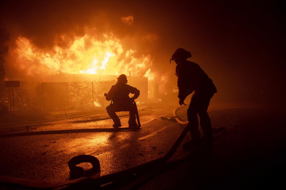 Firefighters try to save a home on Tigertail Road during the Getty fire, Oct. 28, 2019, in Los Angeles, Calif. (Photo: Christian Monterrosa/AP)