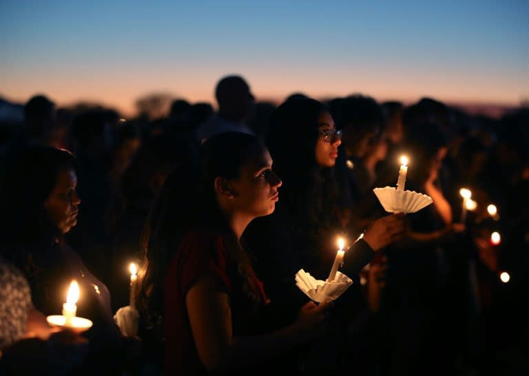 Thousands gathered at sunset for a candlelit vigil at Pine Trails Park, located not far from the scene of the shooting that left 17 people dead