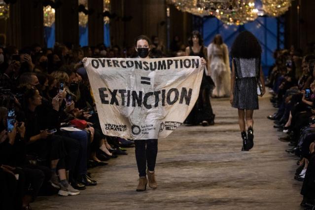 Climate change protester disrupts Louis Vuitton show in Paris